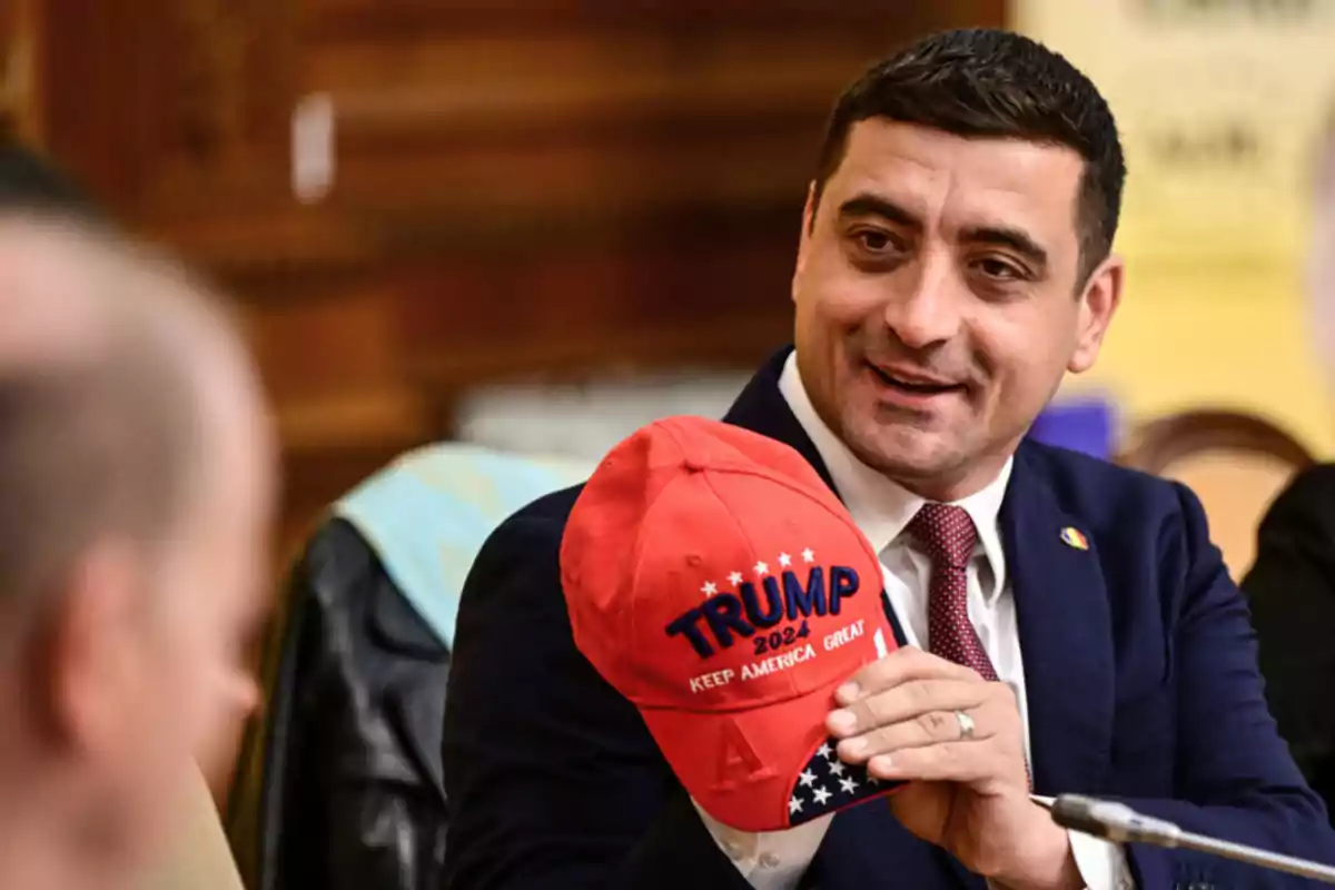 Man in a suit holding a red cap with the text Man in a suit holding a red cap with the text