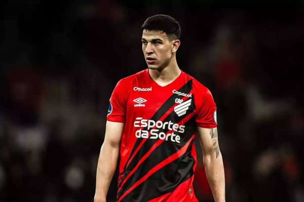A player in a red and black uniform on the field. A player in a red and black uniform on the field.