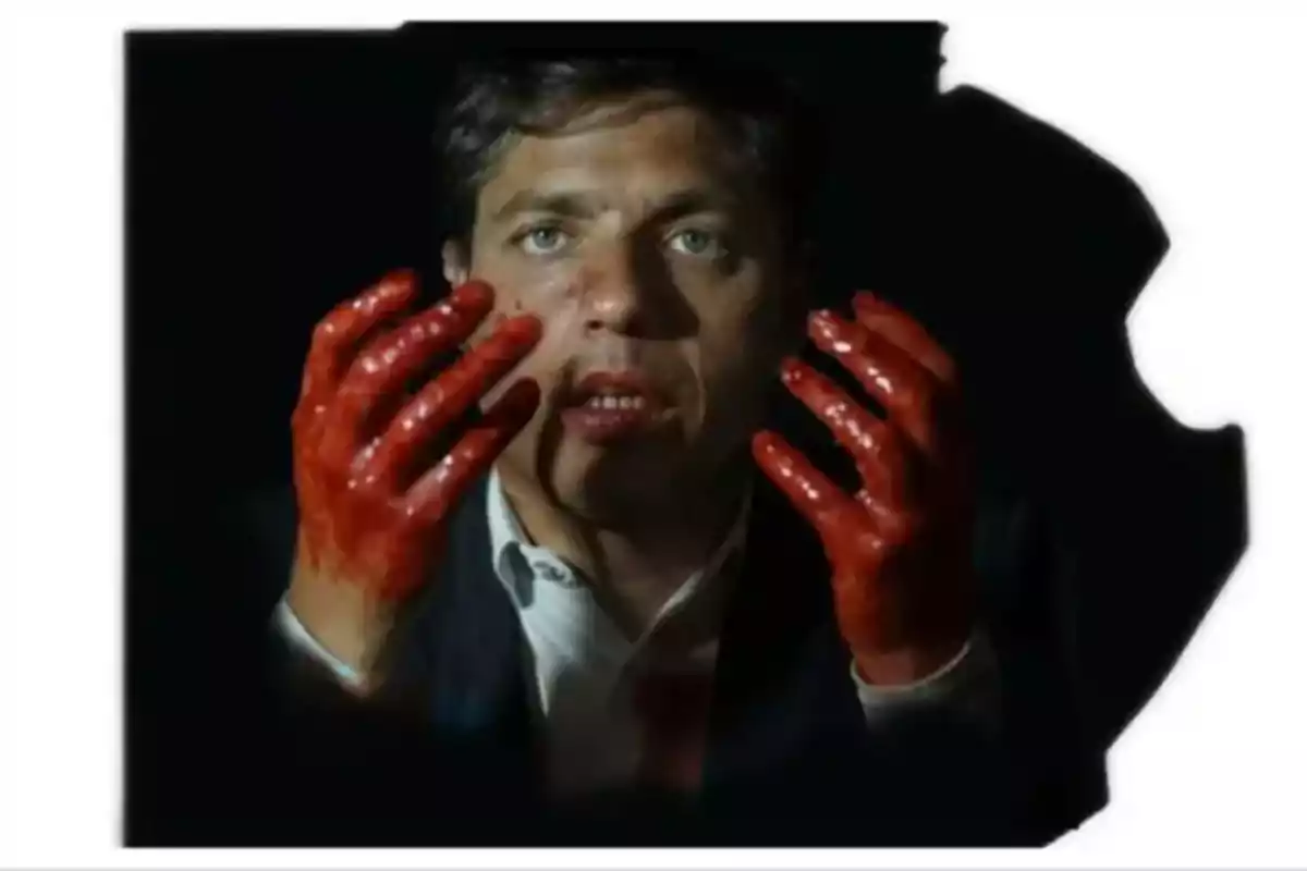 Man with a serious expression and hands covered in what appears to be blood looking straight ahead