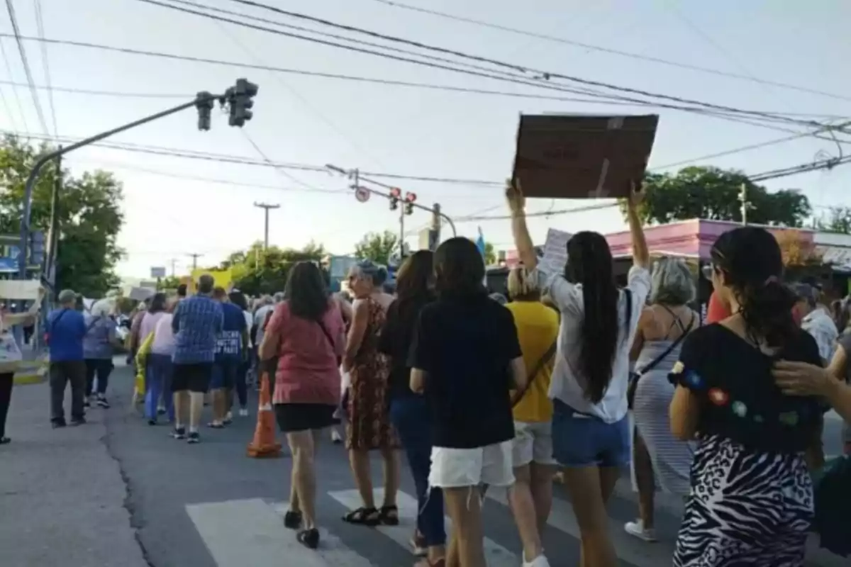A group of people is walking down the street during a demonstration, some are carrying signs, and the atmosphere is one of peaceful protest. A group of people is walking down the street during a demonstration, some are carrying signs, and the atmosphere is one of peaceful protest.