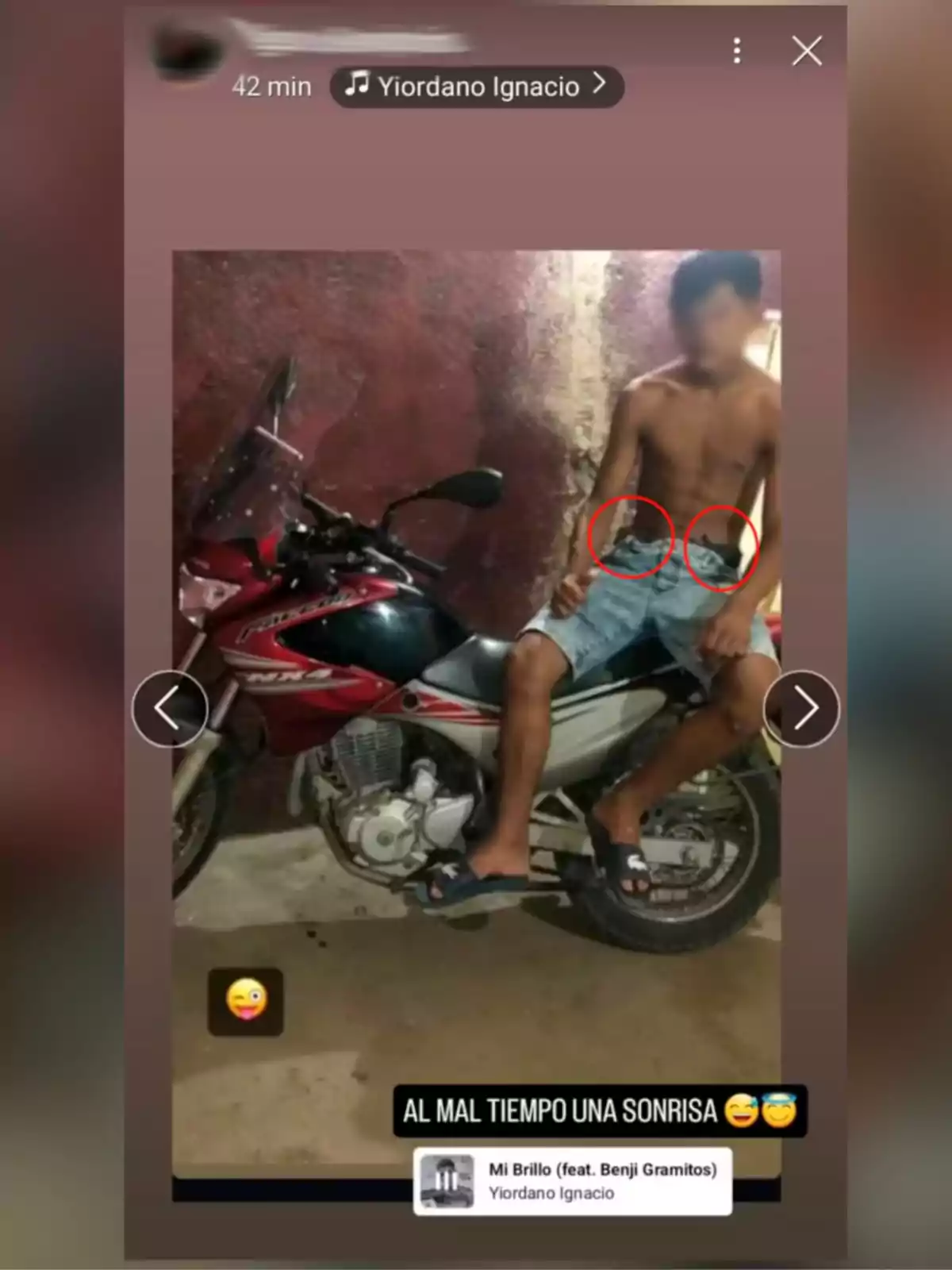 Shirtless young man sitting on a red motorcycle next to a wall, with two red circles marking his pants and text at the bottom that says Shirtless young man sitting on a red motorcycle next to a wall, with two red circles marking his pants and text at the bottom that says