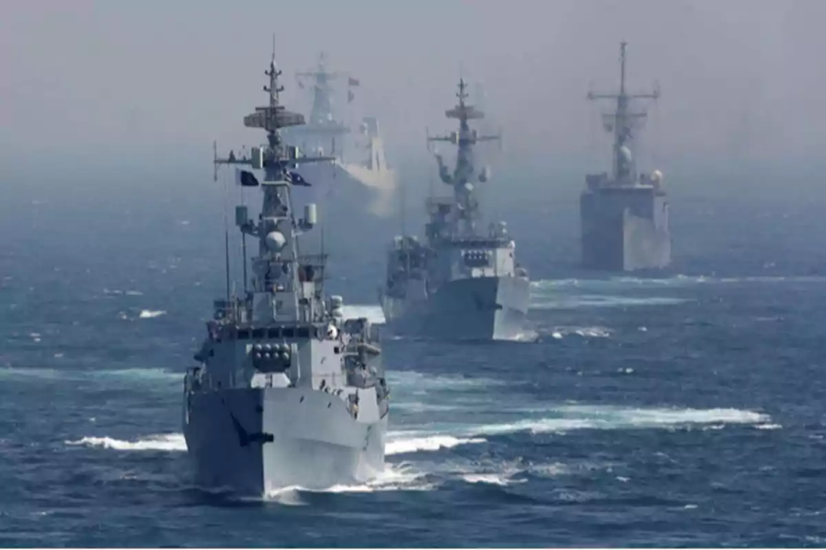 Warships sailing in formation in the ocean. Warships sailing in formation in the ocean.