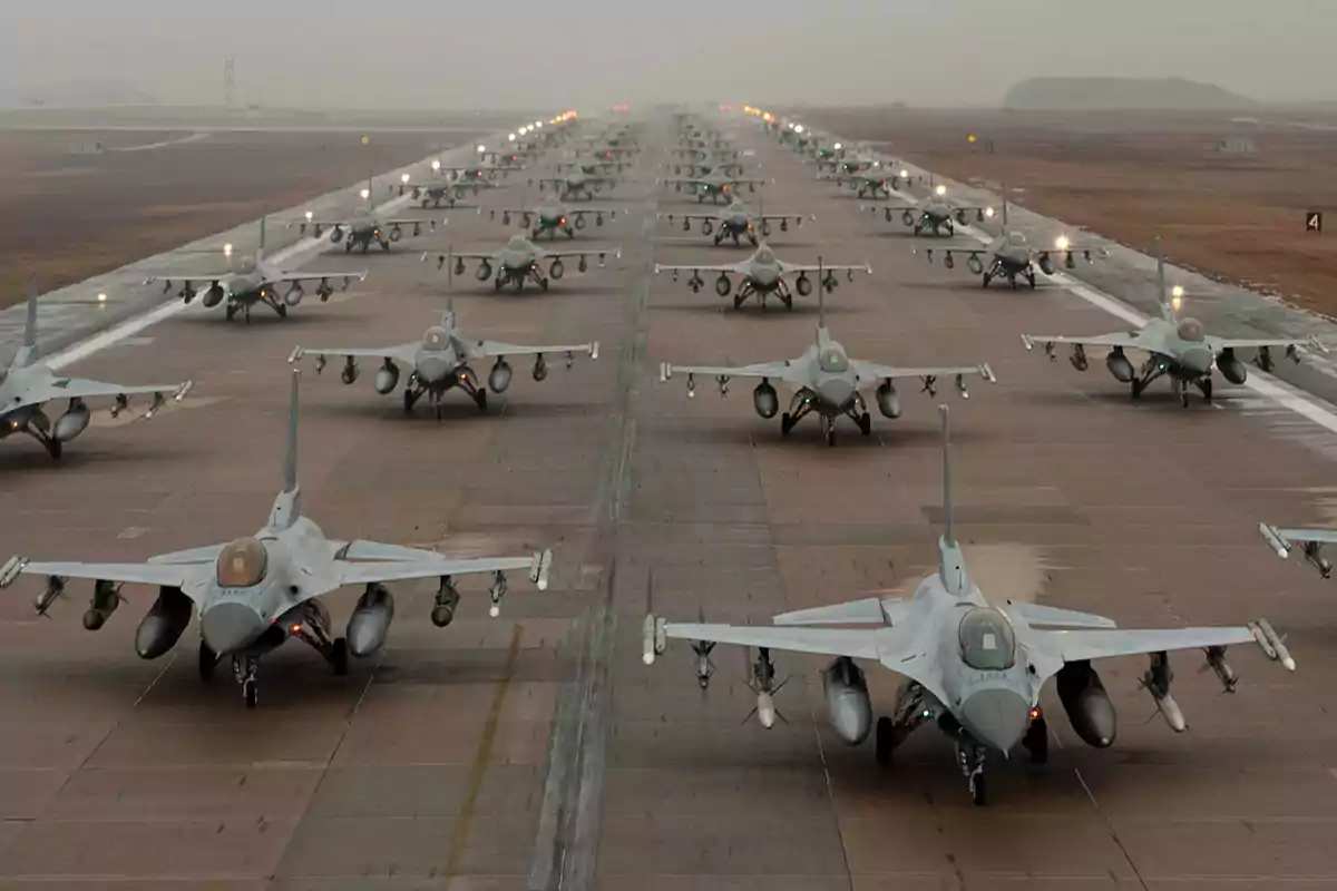 A formation of fighter jets on a runway.