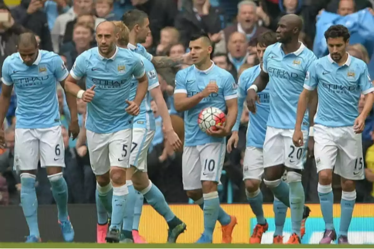 Soccer players in light blue uniforms walking together on the field. Soccer players in light blue uniforms walking together on the field.