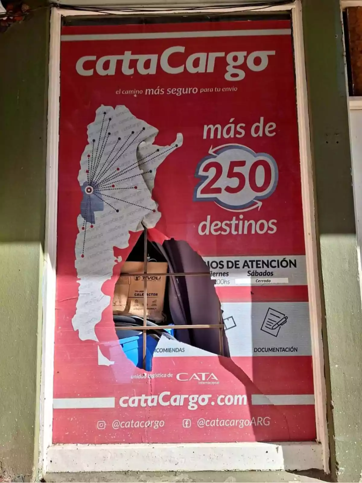 Advertising billboard for a shipping company with a large hole in the center revealing stored boxes behind. Advertising billboard for a shipping company with a large hole in the center revealing stored boxes behind.