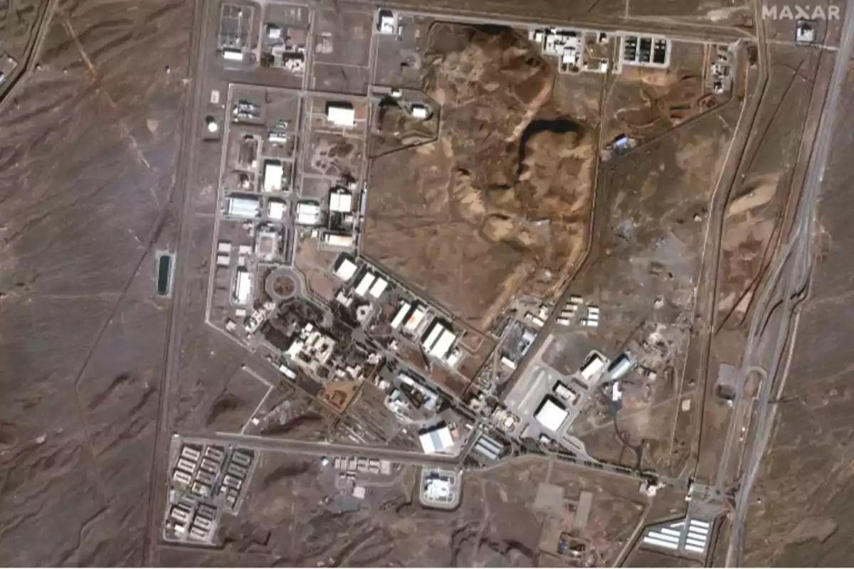 Aerial view of an industrial complex surrounded by arid land with several buildings and internal roads Aerial view of an industrial complex surrounded by arid land with several buildings and internal roads
