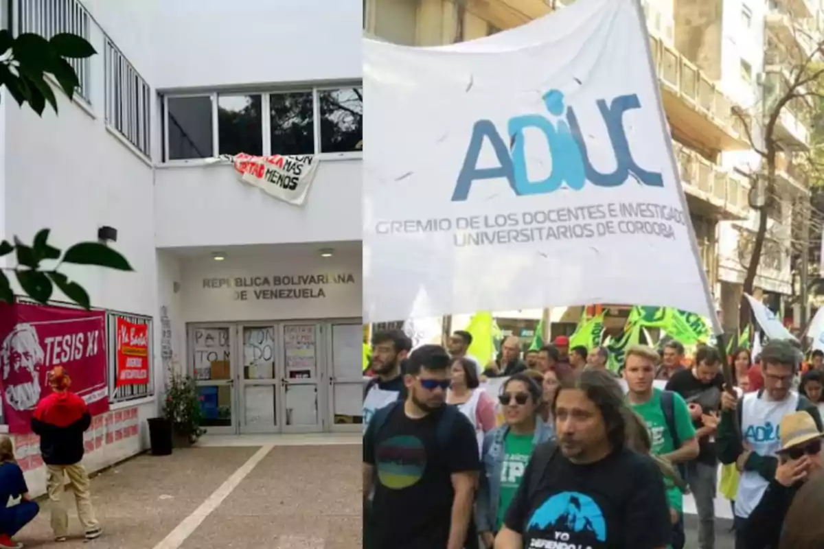 People protesting in the street with a large flag of a university union and, next to them, the entrance of a building with posters and banners related to social and political issues.
