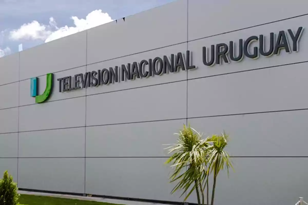 Facade of a modern building with the sign "Televisión Nacional Uruguay" and a plant in the foreground