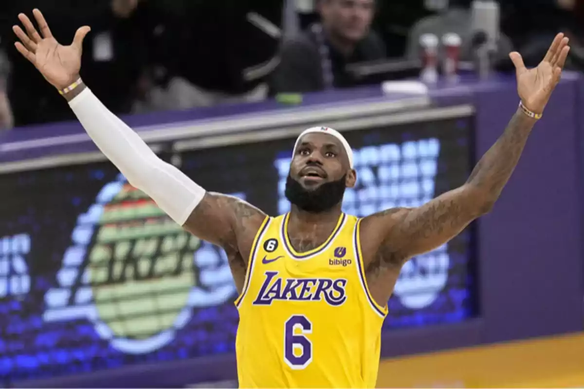 Lakers basketball player wearing number 6 raising his arms in celebration on the court Lakers basketball player wearing number 6 raising his arms in celebration on the court