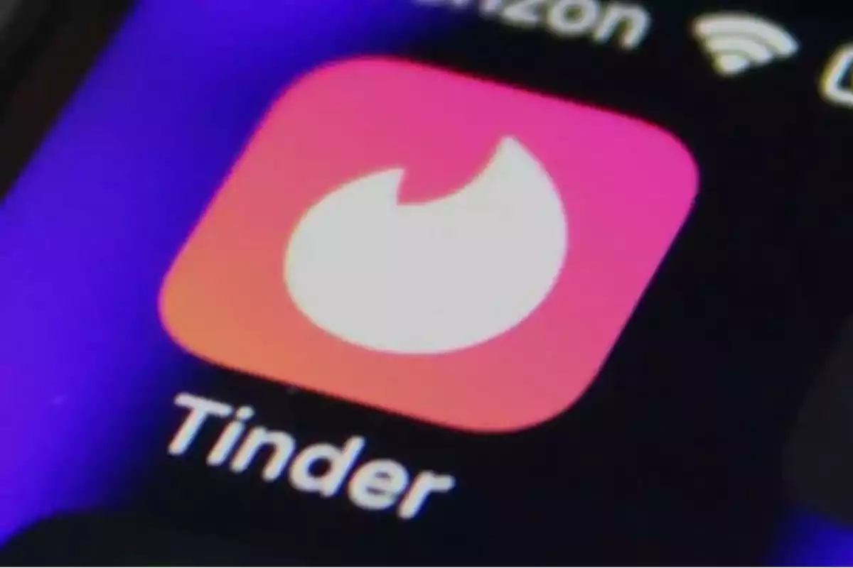Tinder app icon on a mobile phone screen Tinder app icon on a mobile phone screen