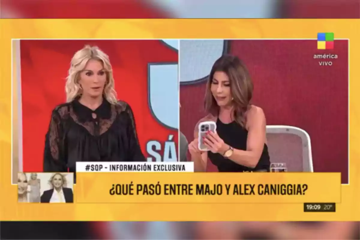 Dos presentadoras de televisión en un programa en vivo discuten sobre una noticia relacionada con Majo y Alex Caniggia, una de ellas sostiene un teléfono móvil y la otra mira hacia el frente, el set tiene fondo rojo y amarillo y en pantalla aparece un recuadro con la pregunta sobre lo que pasó entre Majo y Alex Caniggia. Dos presentadoras de televisión en un programa en vivo discuten sobre una noticia relacionada con Majo y Alex Caniggia, una de ellas sostiene un teléfono móvil y la otra mira hacia el frente, el set tiene fondo rojo y amarillo y en pantalla aparece un recuadro con la pregunta sobre lo que pasó entre Majo y Alex Caniggia.