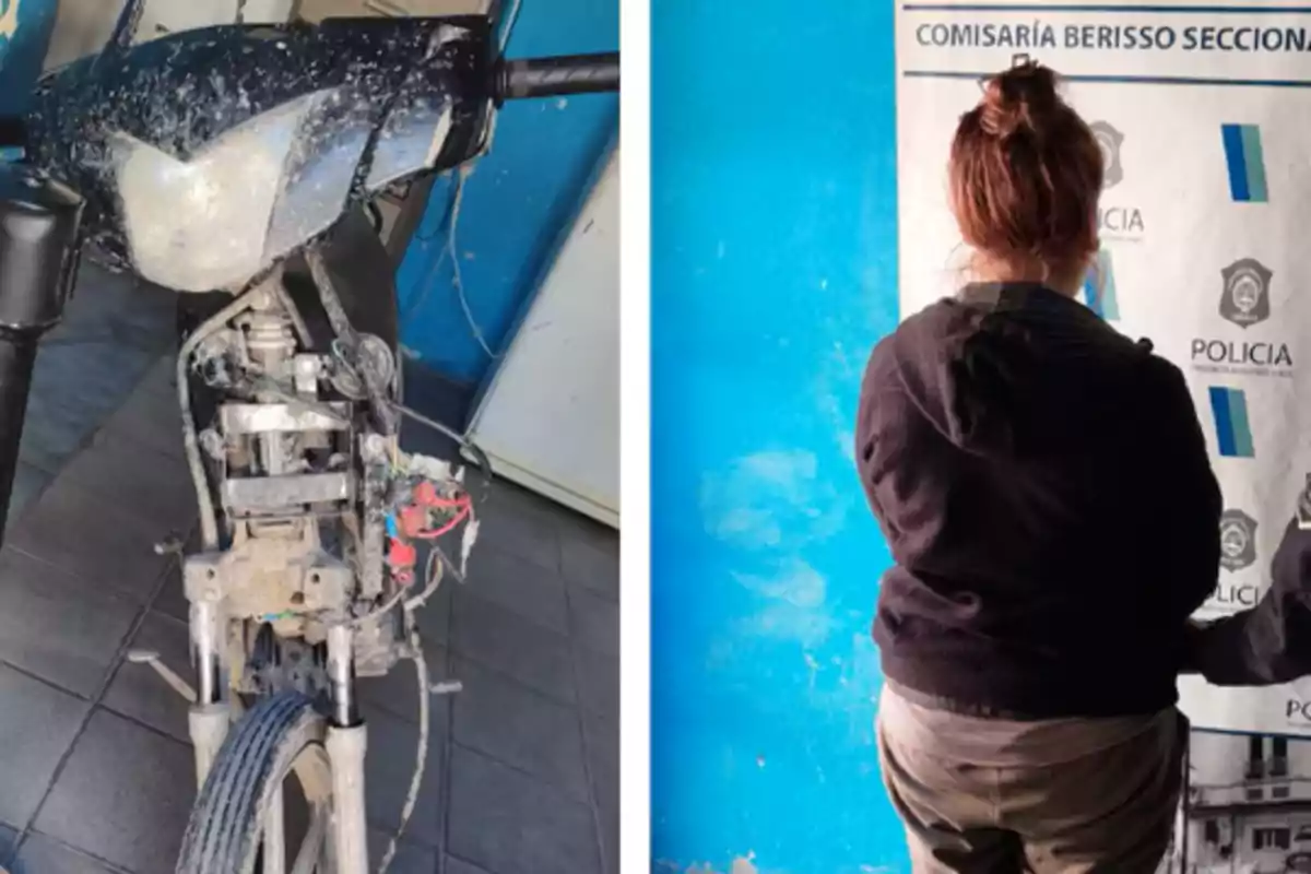 Una motocicleta dañada junto a una persona de espaldas frente a un cartel policial