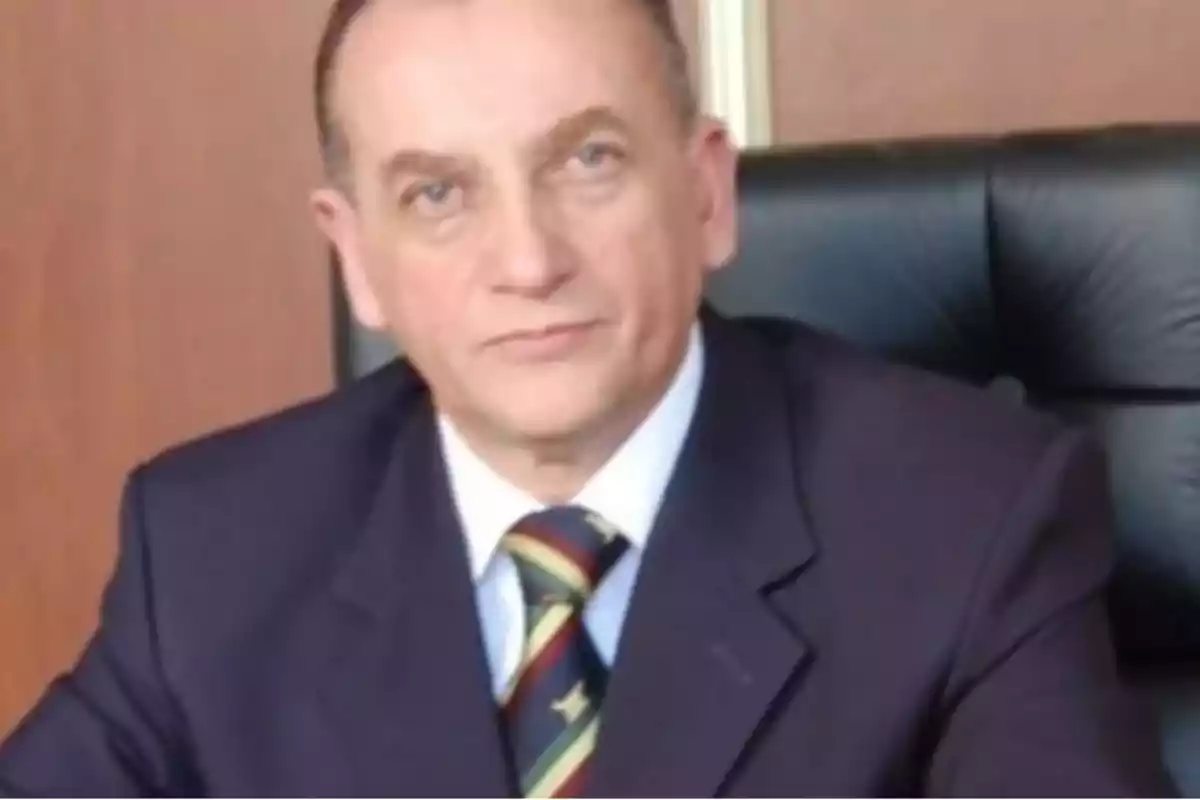 Middle-aged man in a dark suit and tie sitting in an executive chair Middle-aged man in a dark suit and tie sitting in an executive chair