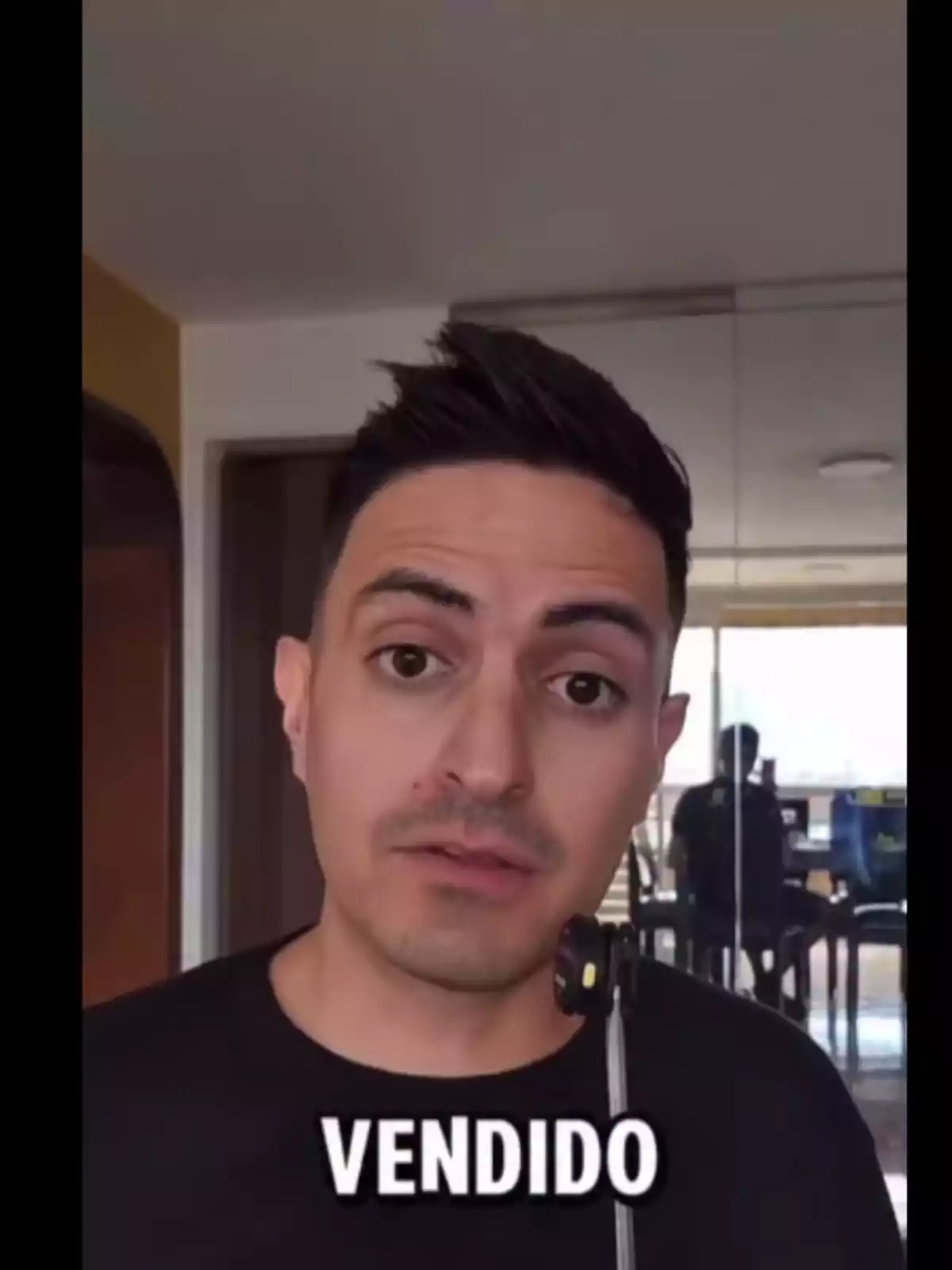 Short dark-haired man looking at the camera with the word Short dark-haired man looking at the camera with the word