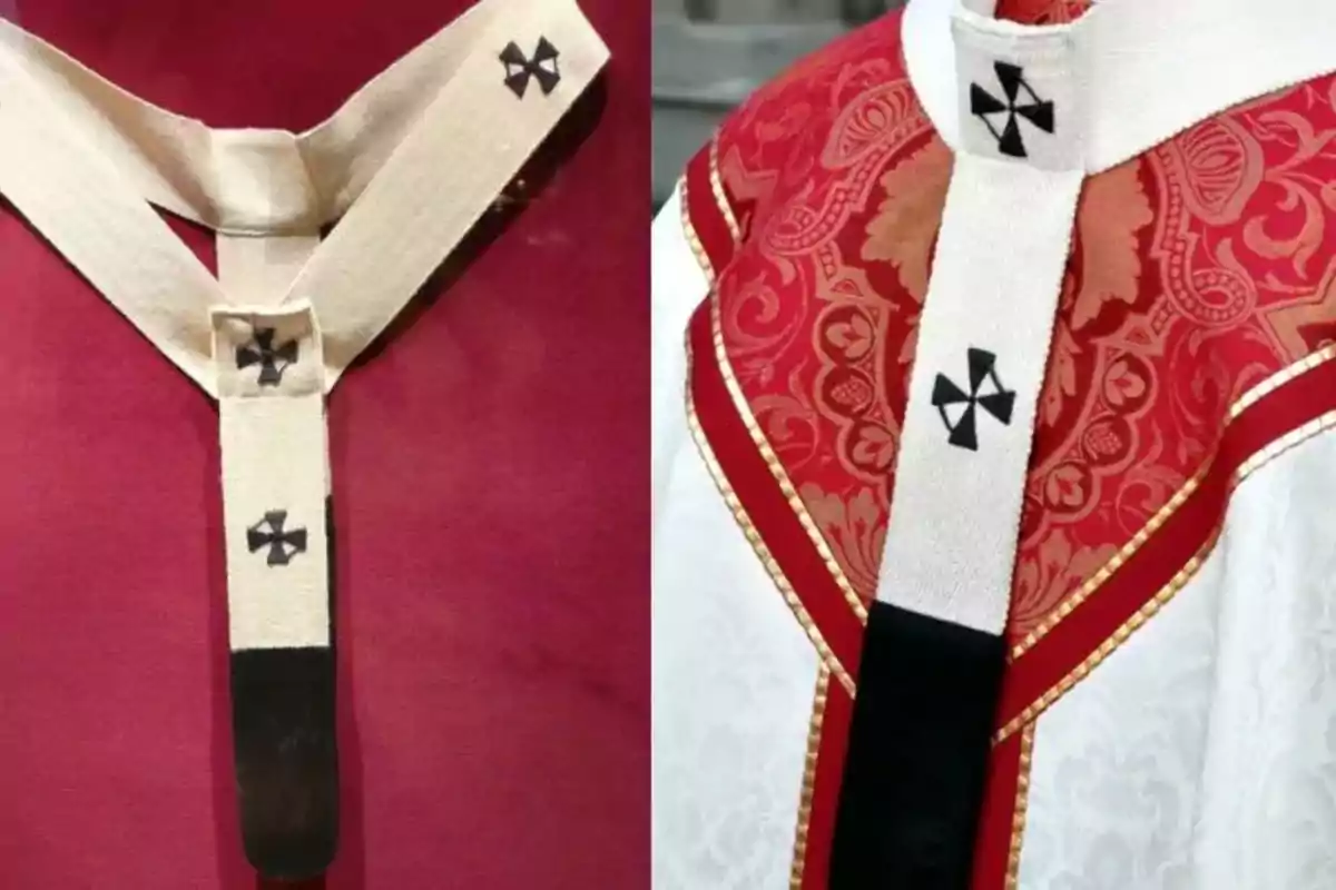 Detail of a white wool pallium with black crosses worn over red and white liturgical vestments Detail of a white wool pallium with black crosses worn over red and white liturgical vestments