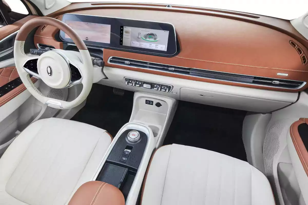 Modern car interior with beige and brown leather seats, two-tone steering wheel, and a panoramic digital display on the dashboard Modern car interior with beige and brown leather seats, two-tone steering wheel, and a panoramic digital display on the dashboard