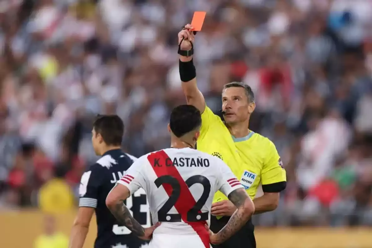 Referee showing a red card to a player during a soccer match Referee showing a red card to a player during a soccer match