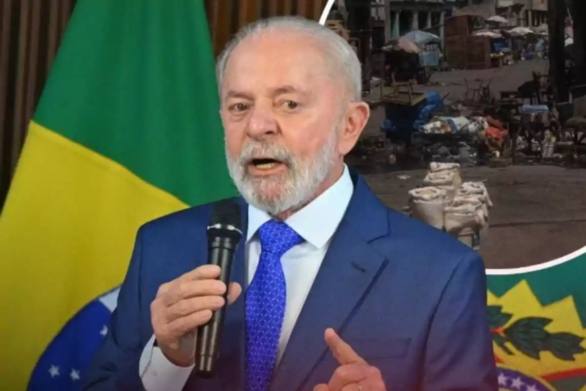 Hombre de cabello y barba canosos con traje azul y corbata azul hablando frente a un micrófono con una bandera de Brasil de fondo y una escena urbana en la esquina superior derecha