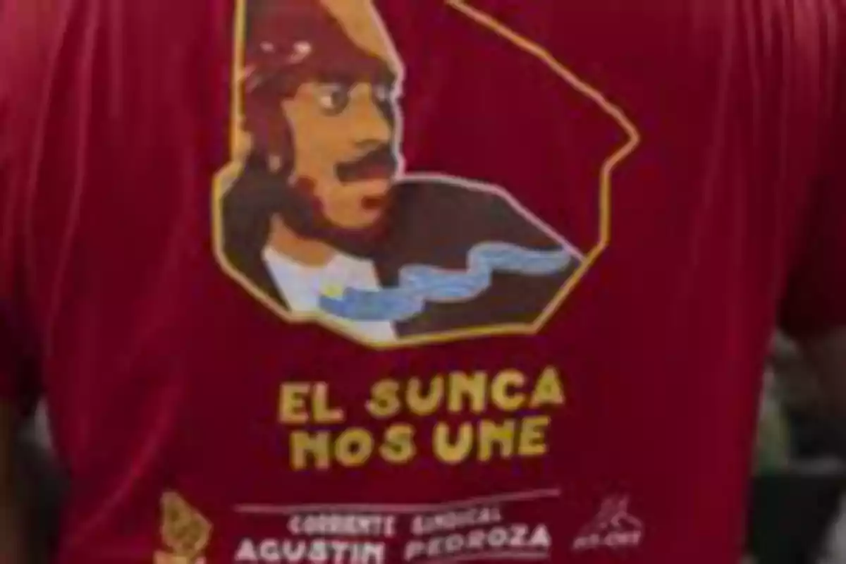 Person wearing a red t-jersey with a drawing of a man and the text Person wearing a red t-jersey with a drawing of a man and the text