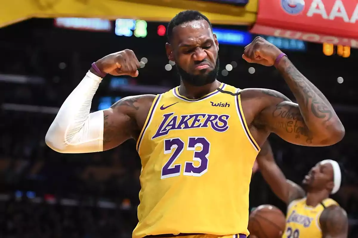 Lakers player wearing number 23 celebrating and showing off his muscles on the basketball court Lakers player wearing number 23 celebrating and showing off his muscles on the basketball court