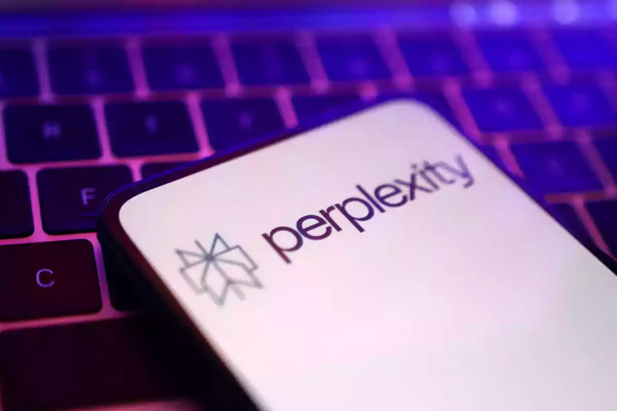 Mobile phone with the Perplexity logo on a keyboard lit in purple tones Mobile phone with the Perplexity logo on a keyboard lit in purple tones