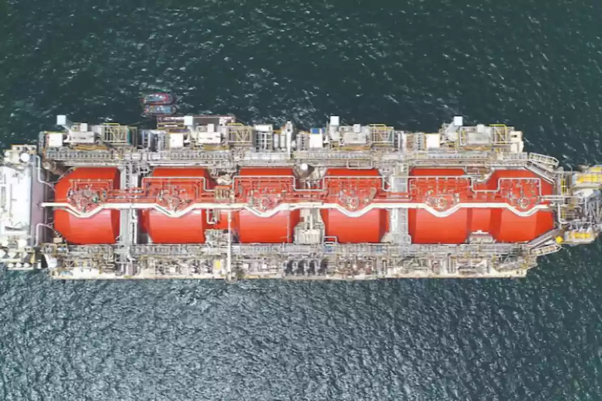 Aerial view of an industrial vessel with large red tanks sailing in the sea Aerial view of an industrial vessel with large red tanks sailing in the sea