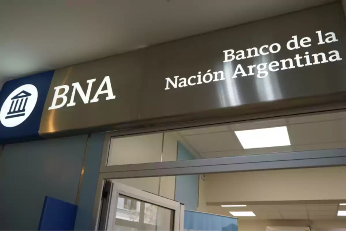 Neon sign of a Banco de la Nación Argentina branch at the entrance of a building Neon sign of a Banco de la Nación Argentina branch at the entrance of a building