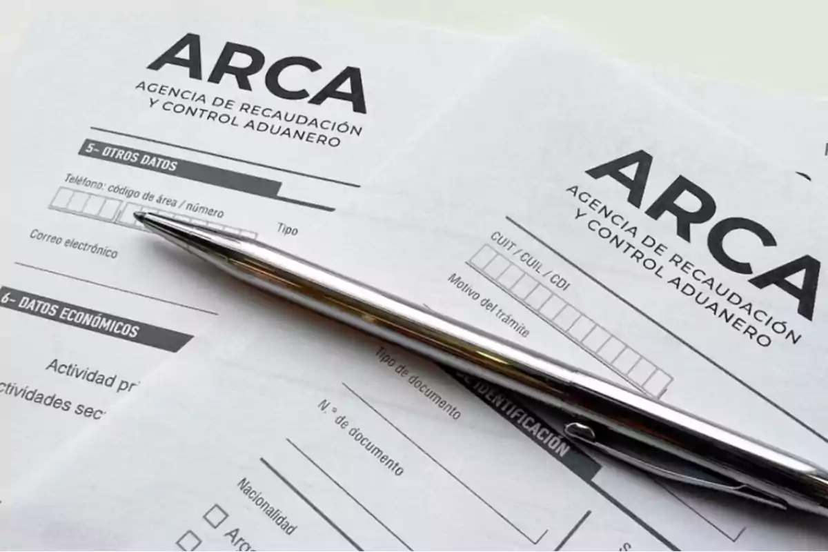 Forms from the Revenue and Customs Control Agency with a silver pen on top