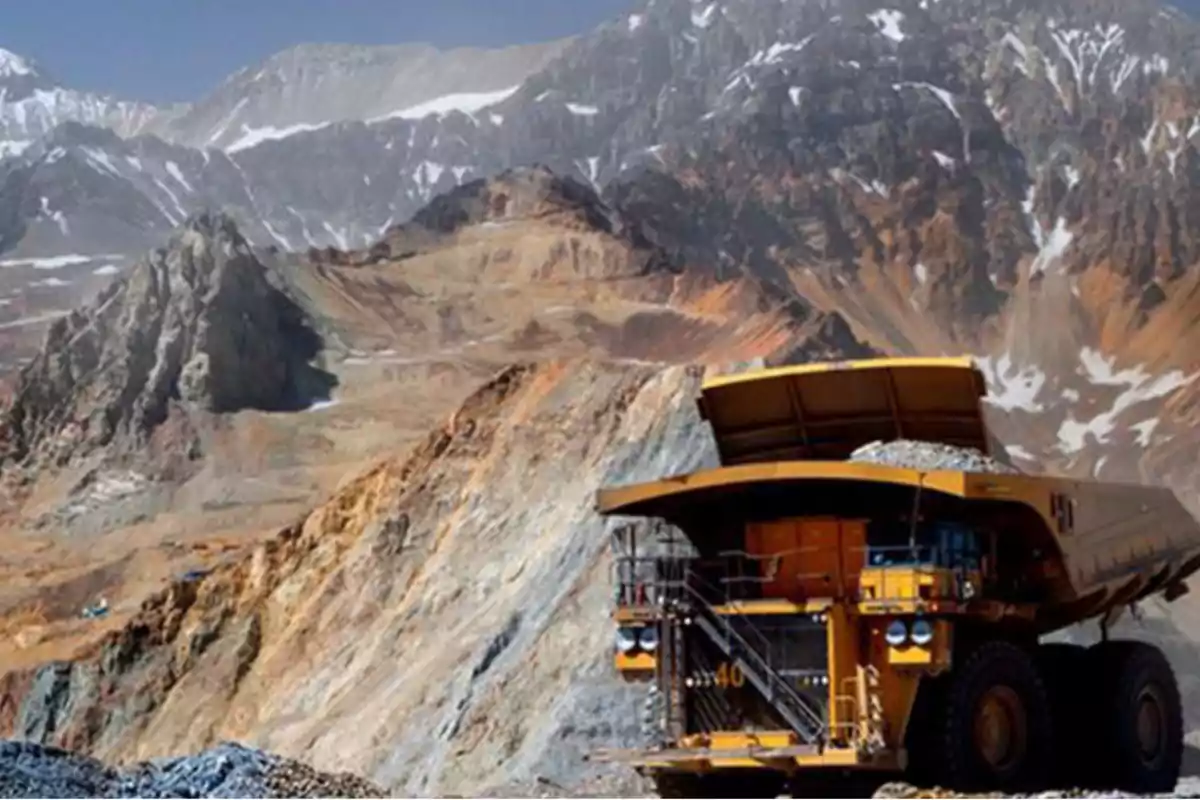 Mining truck hauling material in an open-pit mine surrounded by rocky mountains Mining truck hauling material in an open-pit mine surrounded by rocky mountains