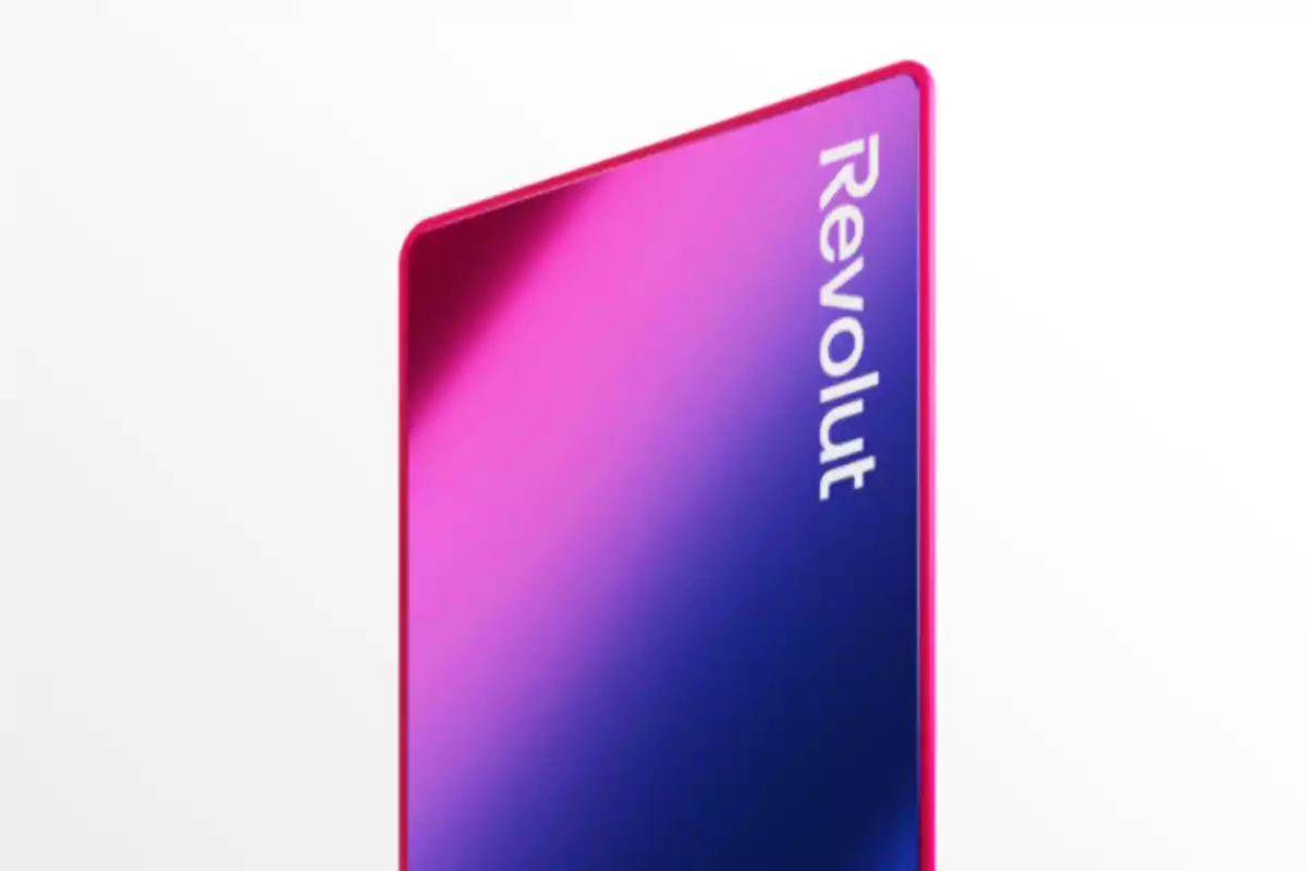 Pink and blue bank card with the Revolut logo in a vertical position on a white background
