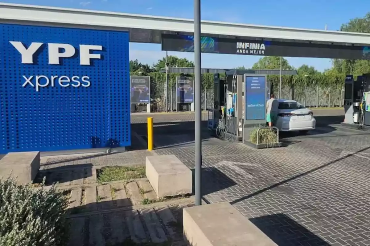 YPF xpress gas station with a white car refueling at one of the pumps under a clear sky