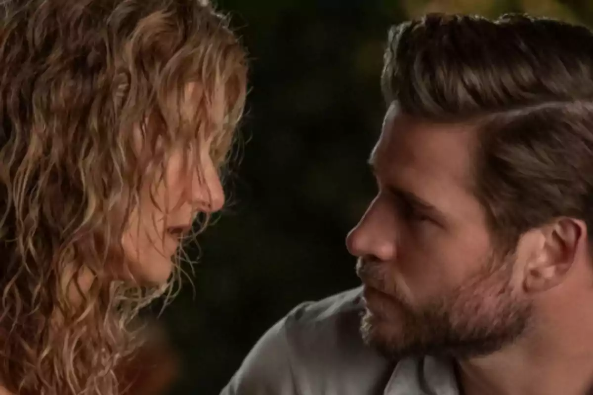 Two people staring at each other at close range in a dimly lit setting Two people staring at each other at close range in a dimly lit setting