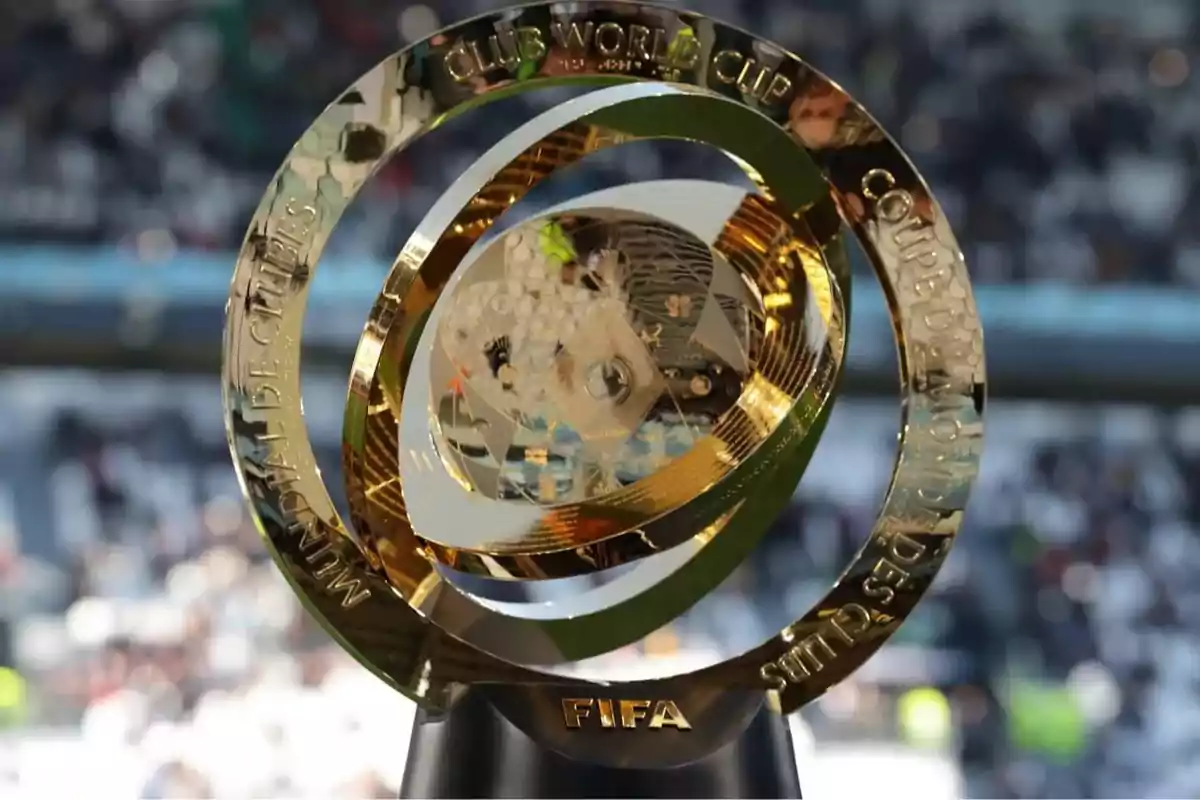 FIFA Club World Cup golden trophy with a blurred stadium background