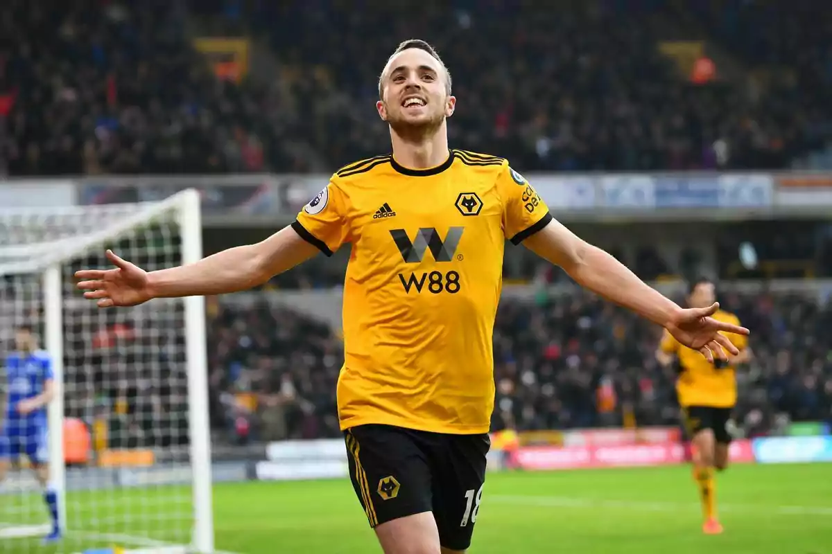 Wolverhampton player celebrating a goal with arms outstretched in a stadium full of fans Wolverhampton player celebrating a goal with arms outstretched in a stadium full of fans