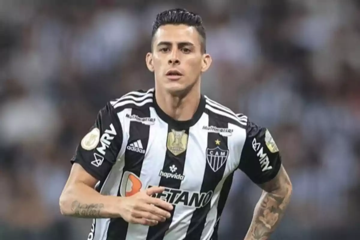 Soccer player in a black and white Atlético Mineiro uniform running on the field during a match Soccer player in a black and white Atlético Mineiro uniform running on the field during a match