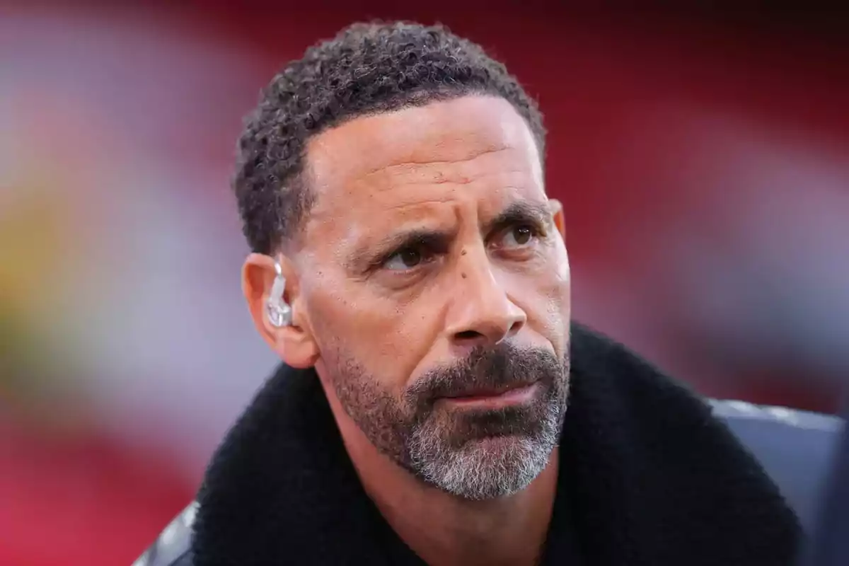 Short-haired, bearded man with a serious expression wearing an earpiece in his left ear Short-haired, bearded man with a serious expression wearing an earpiece in his left ear