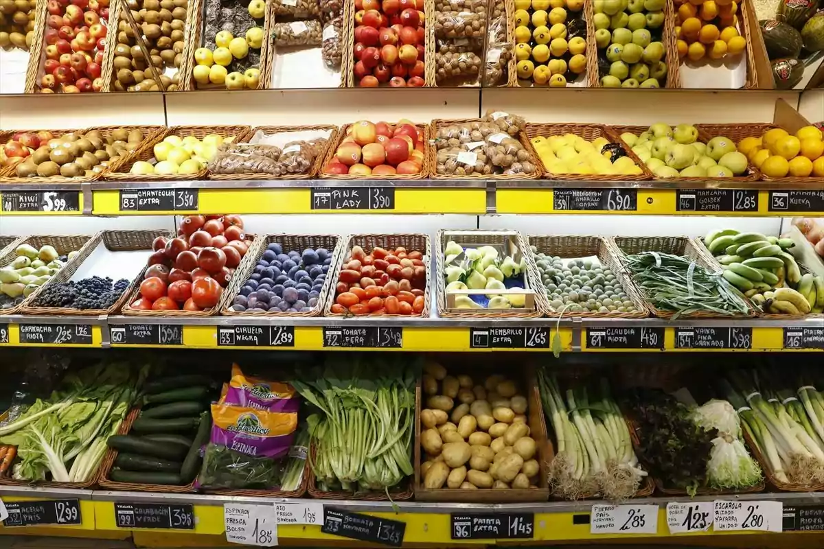 Estantes de supermercado llenos de frutas y verduras frescas organizadas en canastas