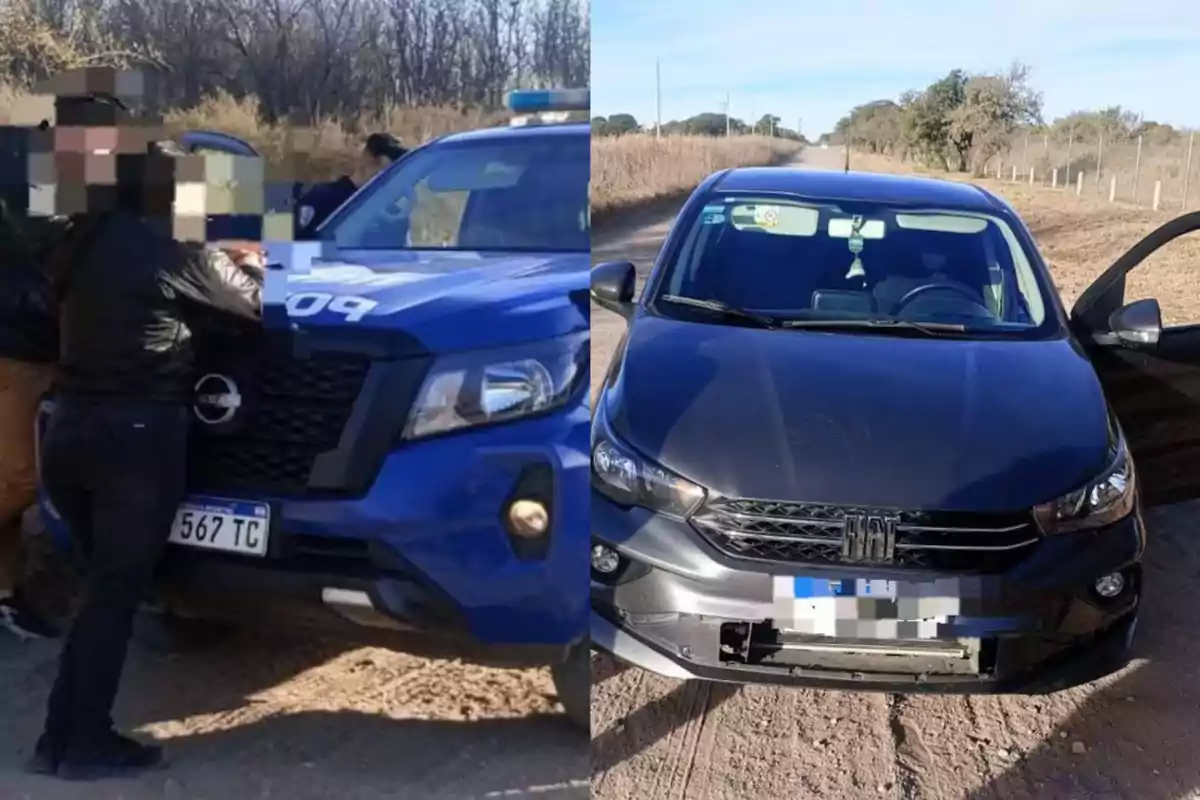 People detained by the police next to a blue patrol car and a black car on a dirt road.