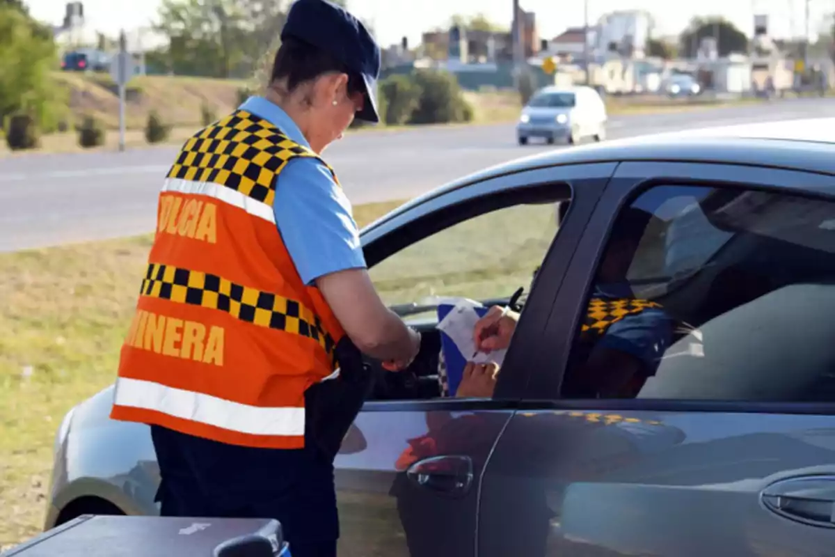 Traffic police officer stopping a driver to check documents at a roadside checkpoint Traffic police officer stopping a driver to check documents at a roadside checkpoint