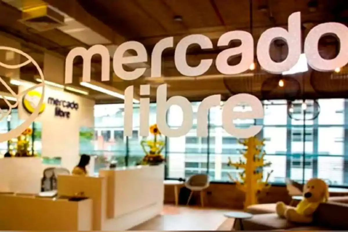 Modern Mercado Libre office with the logo on glass and a yellow plush toy in the reception area
