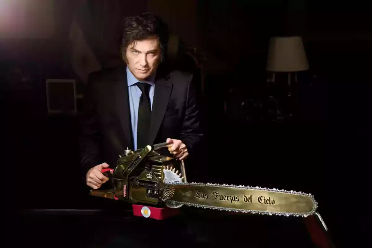 Dark-haired man in a suit holding a golden chainsaw inscribed with The Forces of Heaven in a dark setting