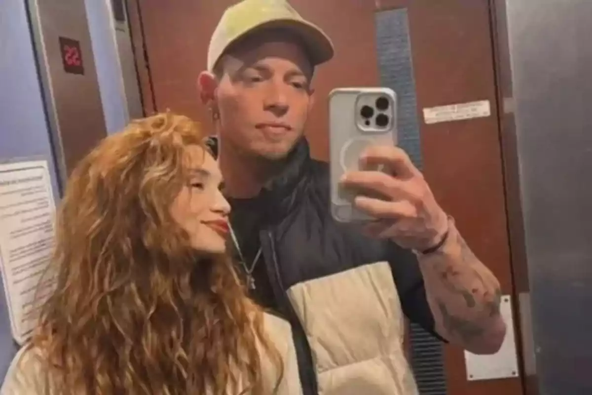 Couple taking a selfie in the elevator mirror
