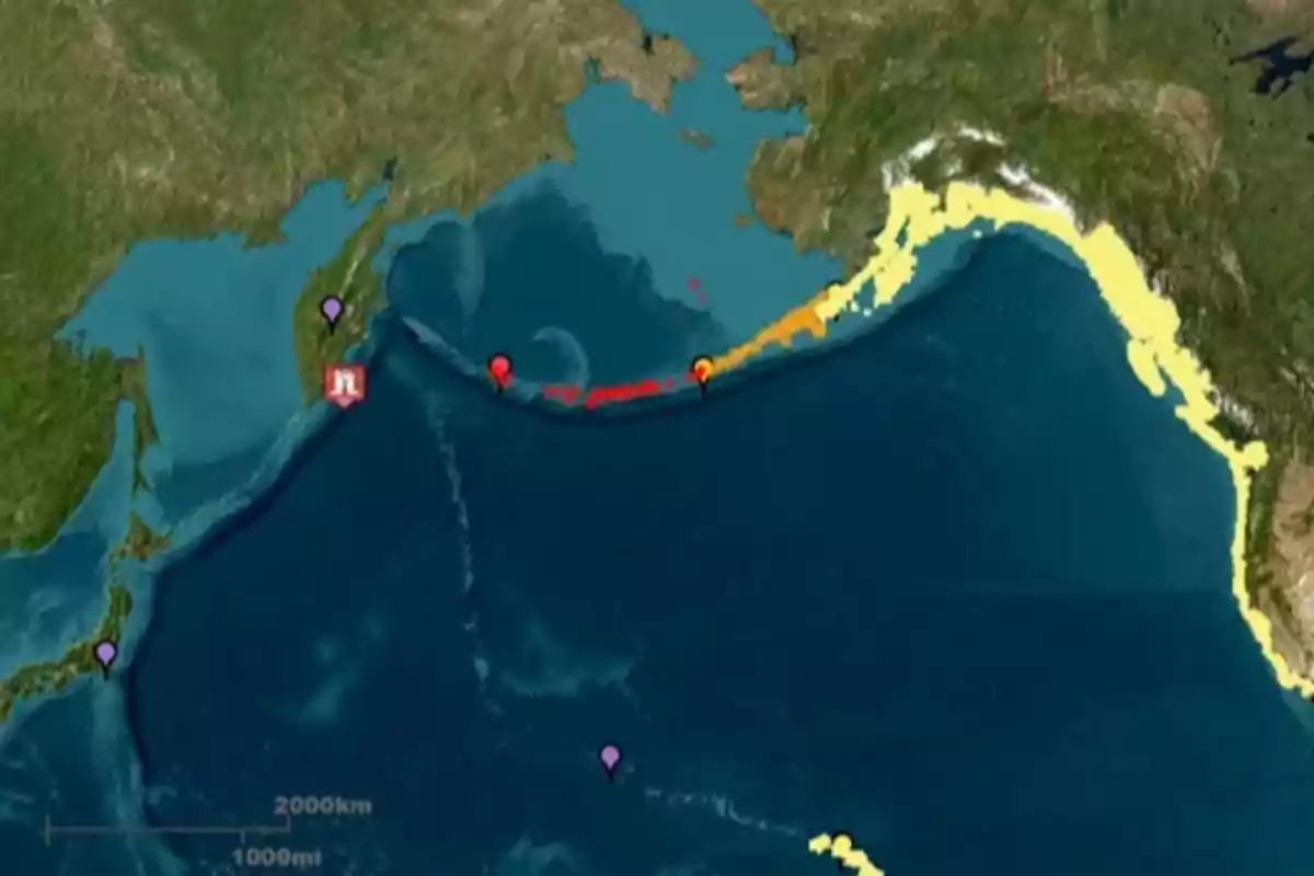 Map showing the North Pacific region with alert markers and coastal areas highlighted in different colors indicating risk levels