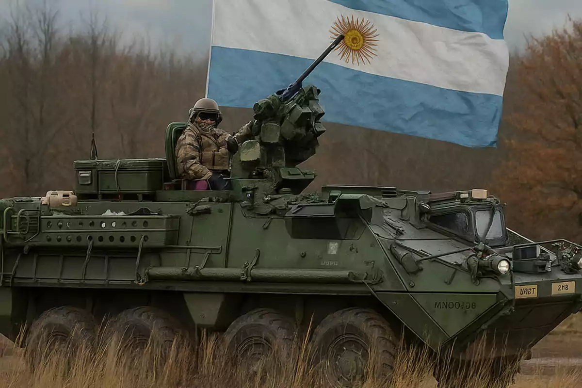 Vehículo blindado militar verde con un soldado a bordo y una gran bandera de Argentina ondeando en la parte superior, en un entorno de campo con árboles al fondo.