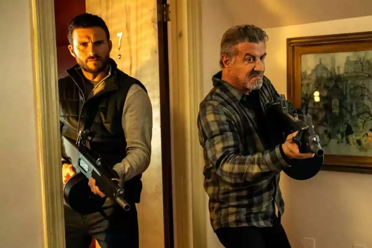 Two men armed with machine guns enter a room with a serious and alert demeanor. Two men armed with machine guns enter a room with a serious and alert demeanor.