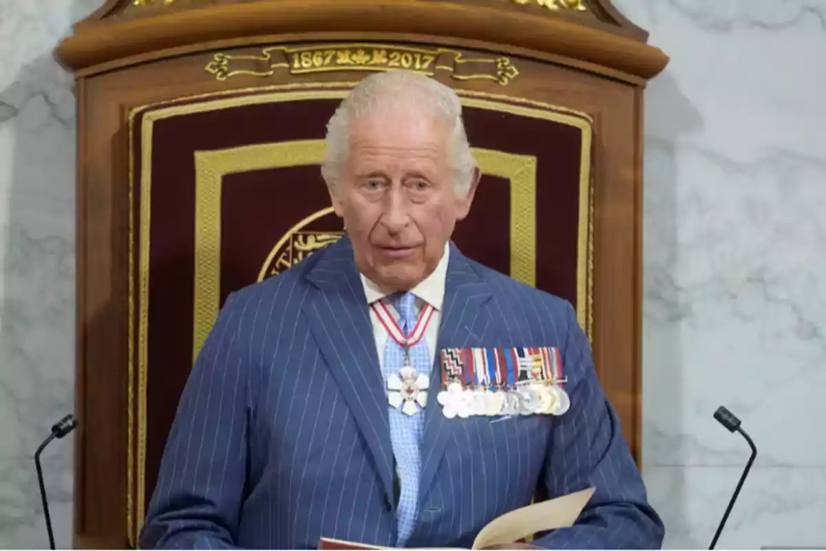 Elderly man with gray hair wearing a blue pinstripe suit and medals on his chest, standing in front of a decorated wooden lectern, holding a book Elderly man with gray hair wearing a blue pinstripe suit and medals on his chest, standing in front of a decorated wooden lectern, holding a book