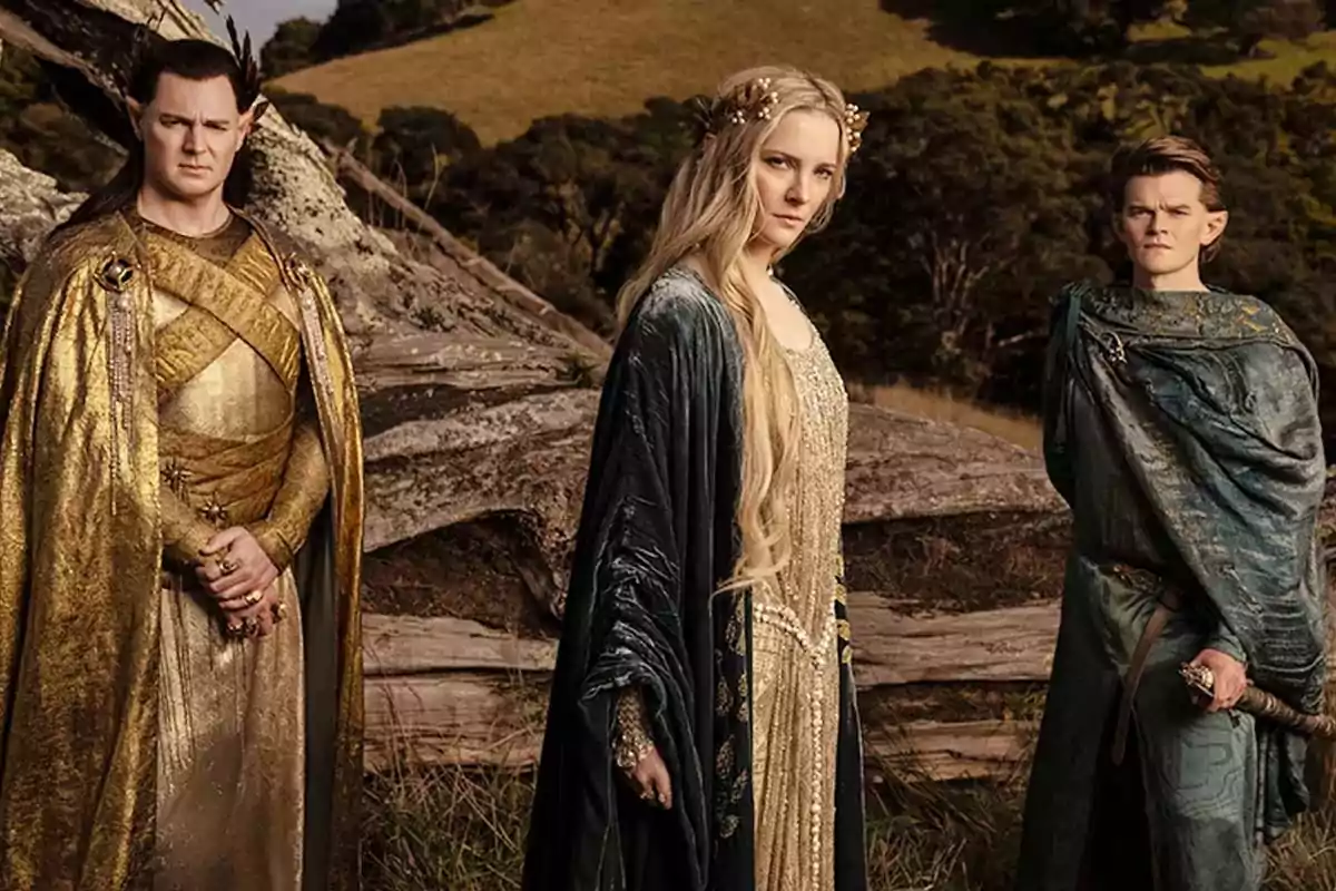 Three characters in elegant medieval attire pose outdoors in front of a fallen log and a natural landscape. Three characters in elegant medieval attire pose outdoors in front of a fallen log and a natural landscape.