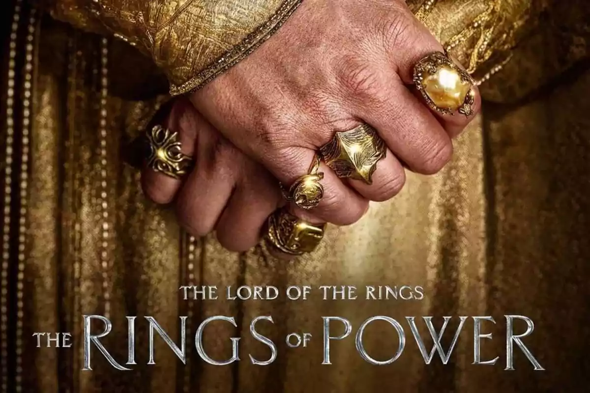 Hand with several golden rings against a golden background and the title The Lord of the Rings The Rings of Power at the bottom Hand with several golden rings against a golden background and the title The Lord of the Rings The Rings of Power at the bottom