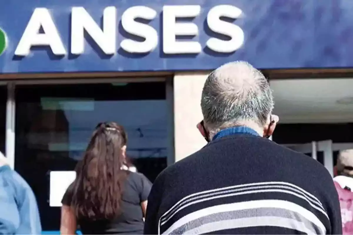 Personas haciendo fila en la entrada de una oficina de ANSES