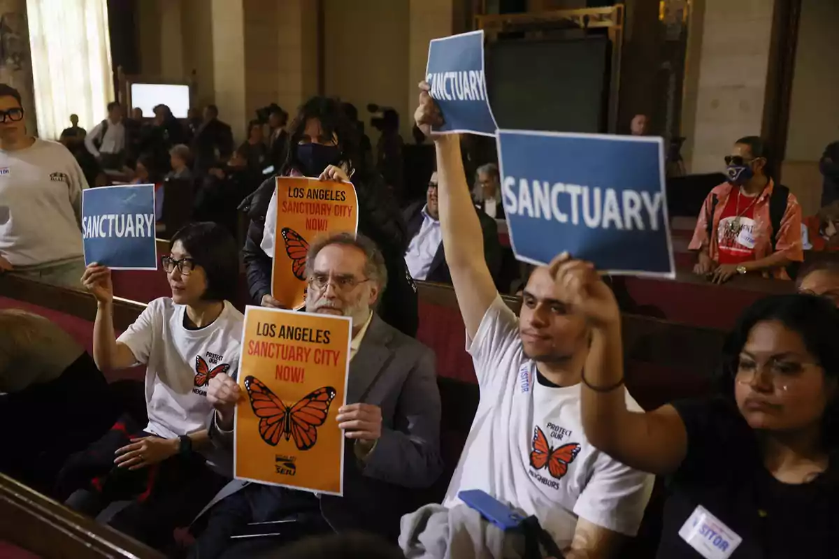 People sitting in a room holding signs that say People sitting in a room holding signs that say
